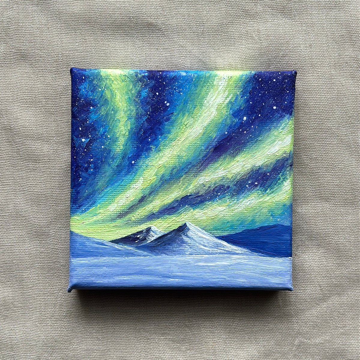Front view of northern lights above snowy mountains, original miniature oil painting.